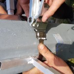 Ręce trzymają metalową rurę - komponenty elektryczne i oświetlenie Polamp.